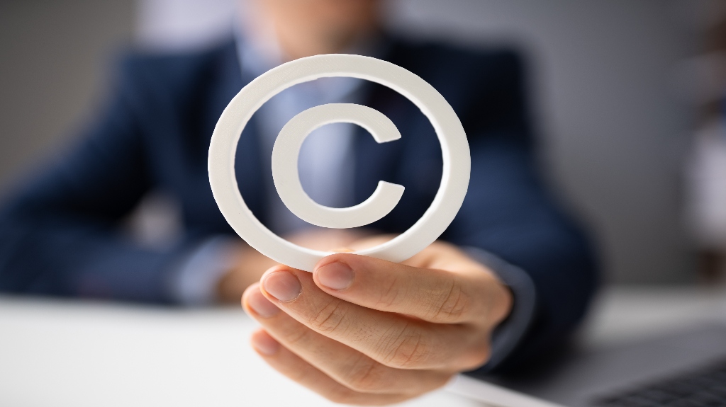 man holding copyright symbol