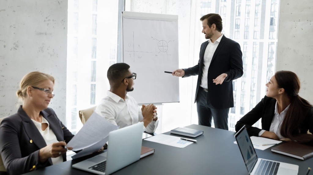 Businesspeople gathered in office board room for making business plans